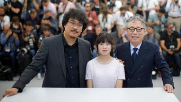 Director Bong Joon-ho and cast member, Seo-Hyeon Ahn and Hee-Bong Byun pose. Reuters