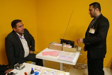 Electoral employees prepare to close voting for the presidential election in a polling station in Tehran, Iran, May 19, 2017.(Reuters)