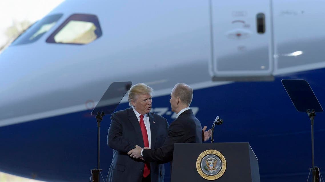 President Donald Trump shakes hands with Boeing CEO Dennis Muilenburg in front of the Boeing 787 Dreamliner during a visit to the Boeing South Carolina facility.  (File photo: AP)