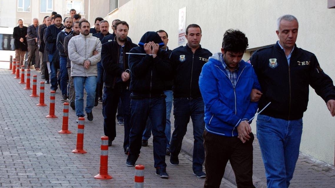 This image obtained from Dogan News Agency (DHA) shows Turkish police officers escorting people after their arrest for alleged links with US-based Muslim cleric Fethullah Gulen on April 26, 2017. (AFP)
