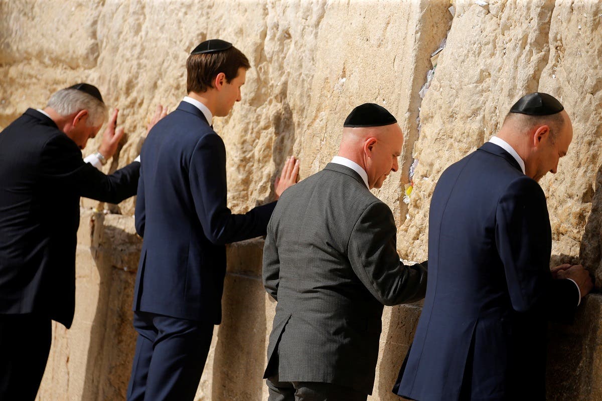Tillerson, Kushner, McMaster and Cohn leave notes at the Western Wall in Jerusalem. (Reuters)