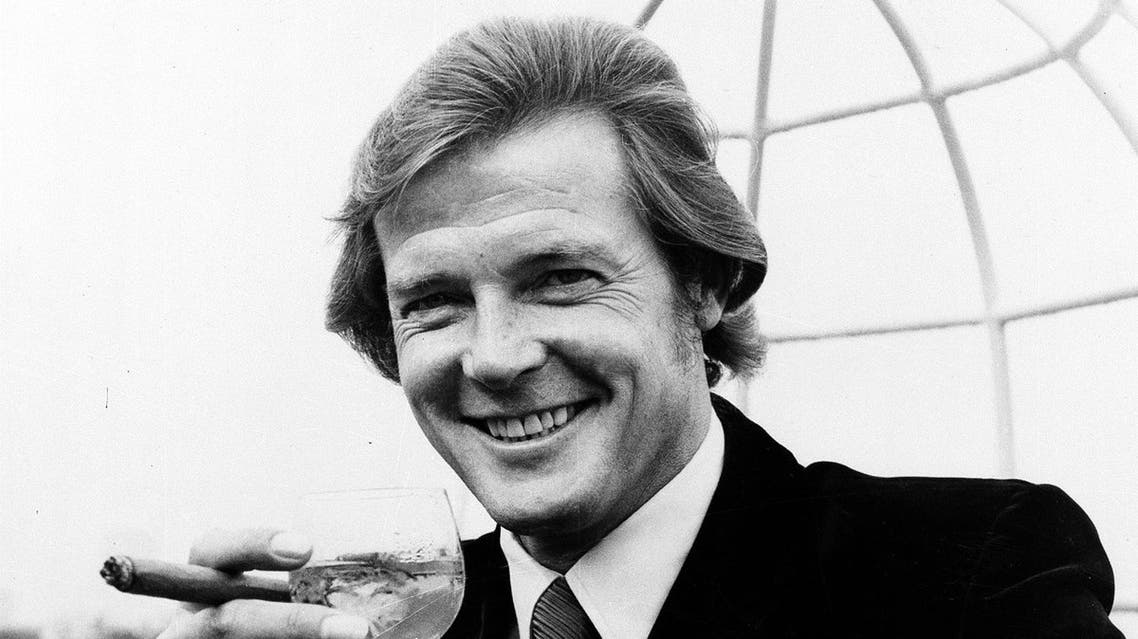 Actor Roger Moore poses with a martini and a big cigar at the Dorchester Hotel in London, on August 1, 1972, after the announcement was made that he will play the British secret agent James Bond 007, in the new production "Live and Let Die." (AP)