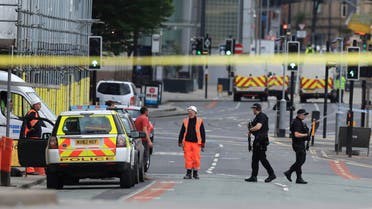Police guard close to the Manchester Arena in Manchester, Britain, Tuesday May 23, 2017. (AP