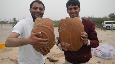 Ali Al Meqbali and Abdulla Al Kaabi holding Dilmun storage jars. (Courtesy: TCA Abu Dhabi)    