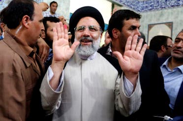 Ebrahim Raisi gestures after casting his ballot for the presidential elections in southern Tehran on May 19, 2017. (AFP)