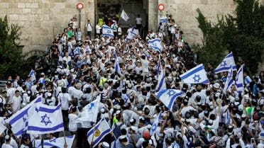 Far right supporters wave Israeli flags as they pass through the Damascus Gate in Jerusalem’s Old City on May 24, 2017. (AFP)