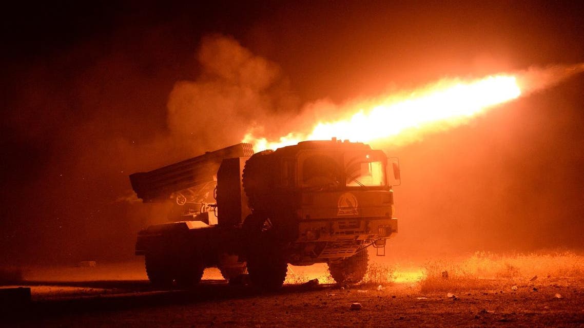 Popular Mobilization Militias fire towards ISIS militants during a battle in Qairawan, west of Mosul. (Reuters)