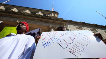 A demonstrator holds a sign denouncing violence against Muslims during a news conference to issue a statement against bigotry and Islamophobia at City Hall in New York September 1, 2010. (Reuters)