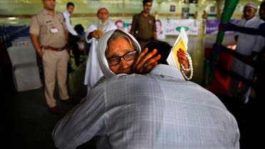 An Indian Muslim woman pilgrim cries as she hugs her son at the airport before leaving for Hajj in New Delhi on Sept. 3, 2014. (AP)