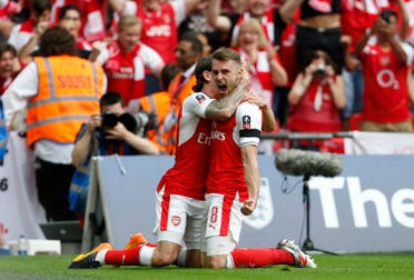 Arsenal's Welsh midfielder Aaron Ramsey (R) celebrates with Arsenal's Spanish defender Hector Bellerin after scoring their second goal during the English FA Cup final football match between Arsenal and Chelsea at Wembley stadium in London on May 27, 2017. (AFP)