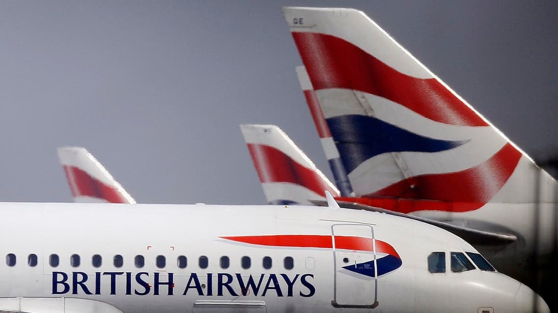 British Airways planes are seen behind fencing at Heathrow airport in London. (AP)