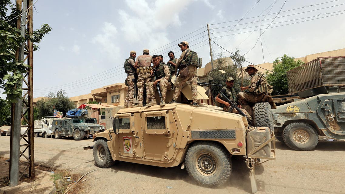Members of Iraqi rapid response force ride in a military vehicle during a battle against Islamic State militants in Mosul, Iraq May 20, 2017.