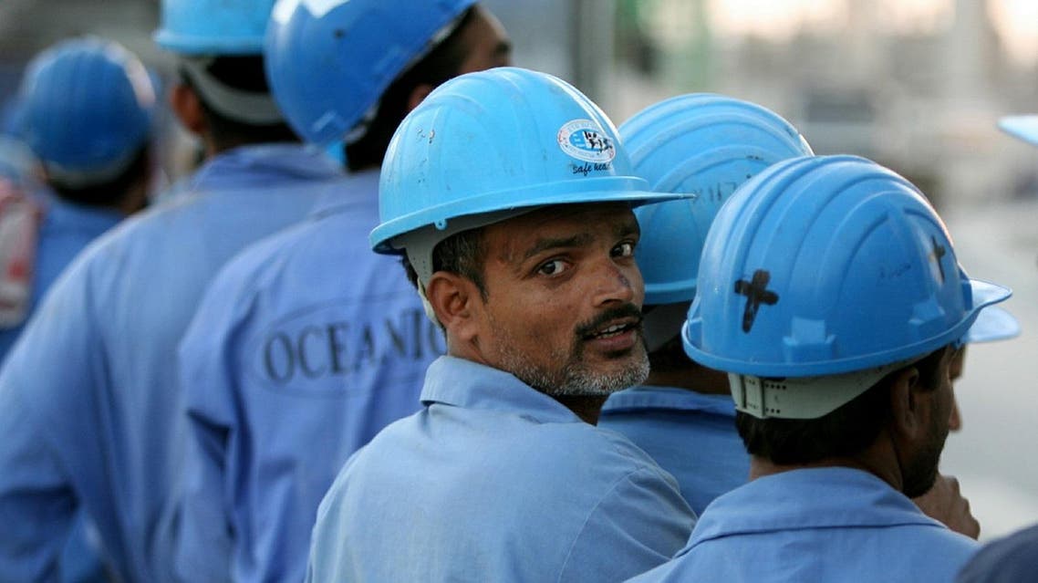 Indian workers line up to board a bus after a day's work in Dubai, November 18, 2005. Many of the workers go unpaid for months, live in overcrowded camps on the outskirts of town, out of sight of five-star hotels which lure millions of tourists from around the world to Dubai. (Reuters)