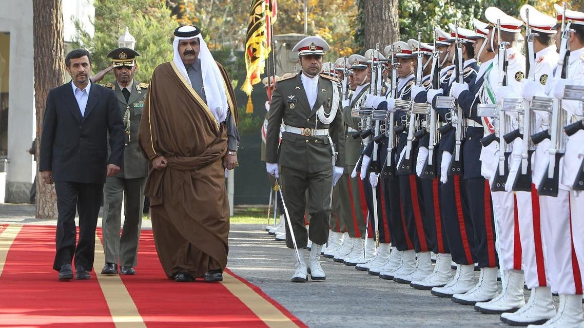 Former Iranian President Mahmoud Ahmadinejad (L) and Former Qatari Emir Sheikh Hamad Bin Khalifa al-Thani inspect the honor guard during a welcoming ceremony prior to their meeting in Tehran in 2010. (AFP)