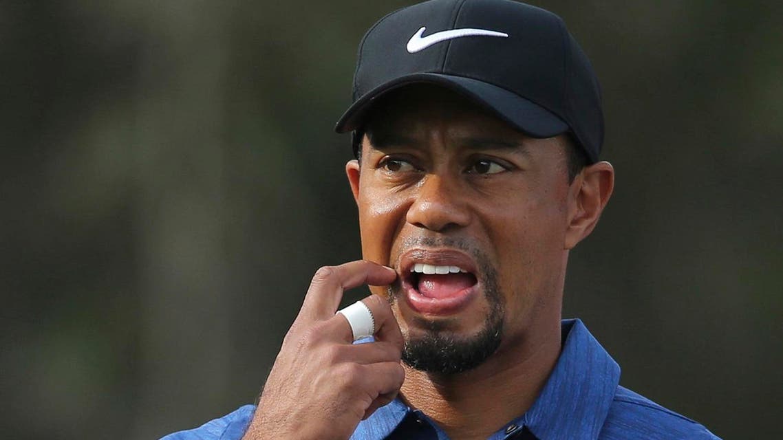 In this Thursday, Feb. 2, 2017, photo, Tiger Woods reacts on hole 11th during the 1st round of the Dubai Desert Classic golf tournament in Dubai, United Arab Emirates. Woods has withdrawn from the Dubai Desert Classic with an apparent back injury after shooting an opening-round 5-over 77. (AP)