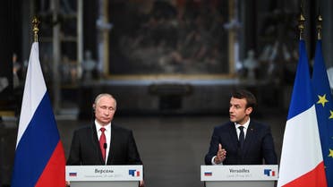 French President Emmanuel Macron (R) delivers a joint press conference with Russian President Vladimir Putin (L) following their meeting at the Versailles Palace, near Paris, on May 29, 2017. French President Emmanuel Macron hosts Russian counterpart Vladimir Putin in their first meeting since he came to office with differences on Ukraine and Syria clearly visible. (AFP)