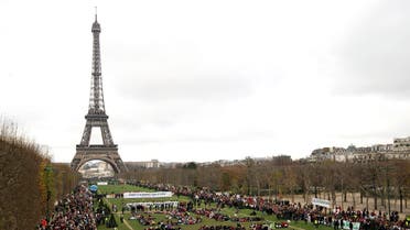 (FILES) This file photo taken on December 12, 2015 shows Several Non Governmental Organisations (NGO)as they gather to form a human chain reading "+3°C SOS" on the Champs de Mars near the Eiffel Tower in Paris on the sidelines of the COP21, the UN conference on global warming. Donald Trump has decided to pull the United States out of the Paris climate accord, US media reported May 31, 2017, as the president kept the world guessing -- saying an announcement will come in the "next few days."An American pullout would deal a devastating blow to global efforts to combat climate change less than 18 months after the historic 196-nation pact was signed in Paris, fruit of a hard-fought agreement between Beijing and Washington under Barack Obama's leadership. (AFP)