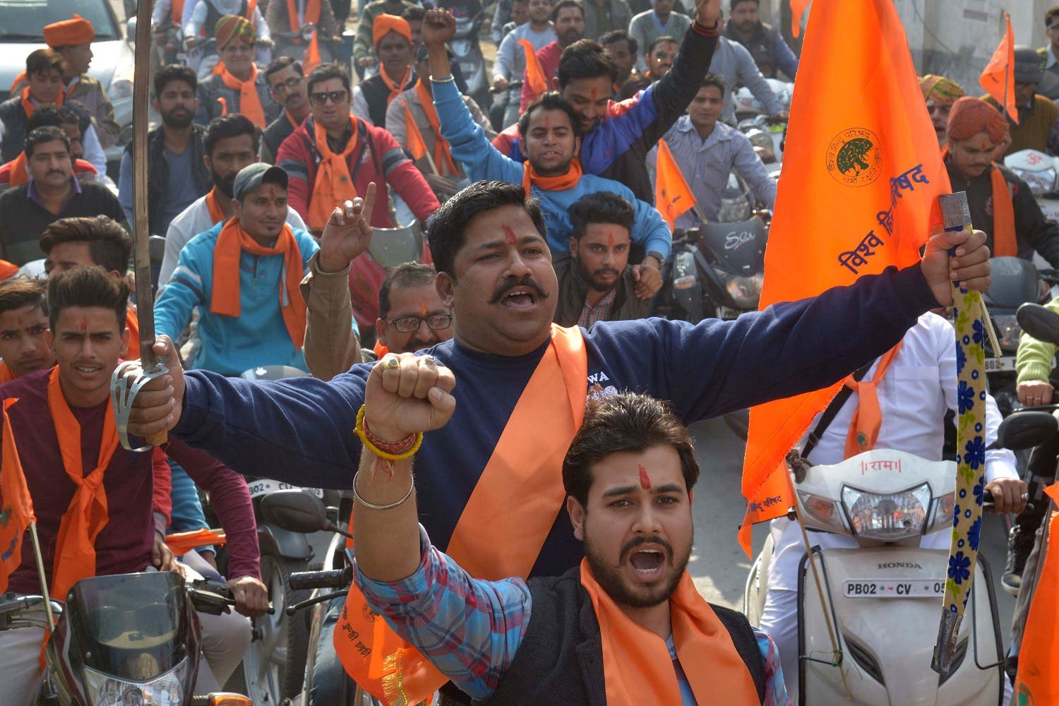 Indian activists of Hindu Bajrang Dal, along with the Vishva Hindu Parishad (VHP), raise religious slogans during a procession marking the 24th anniversary of the demolition of the Babri Masjid Mosque in Ayodhya, in Amritsar on December 6, 2016. (AFP)