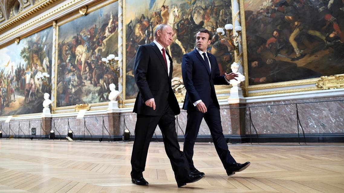 Emmanuel Macron with Vladimir Putin in the Gallery of Battles as they arrive for a joint press conference following their meeting at the Versailles Palace, near Paris, on May 29, 2017. (AFP)