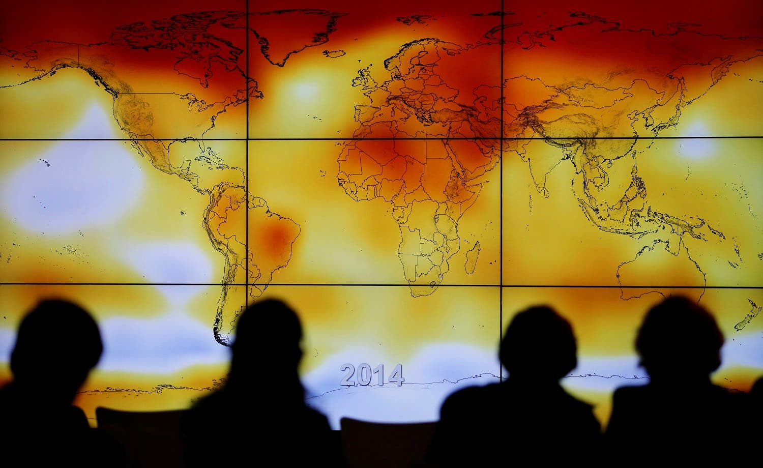 Participants are seen in silhouette as they look at a screen showing a world map with climate anomalies during the World Climate Change Conference 2015 (COP21) in Paris. (File photo: Reuters)