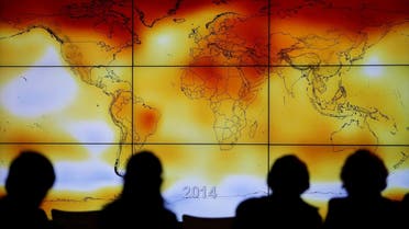 Participants are seen in silhouette as they look at a screen showing a world map with climate anomalies during the World Climate Change Conference 2015 (COP21) in Paris. (File photo: Reuters)