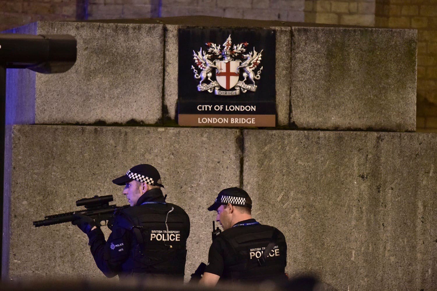 An armed Police officer looks through his weapon on London Bridge in London, Saturday, June 3, 2017. (AP)