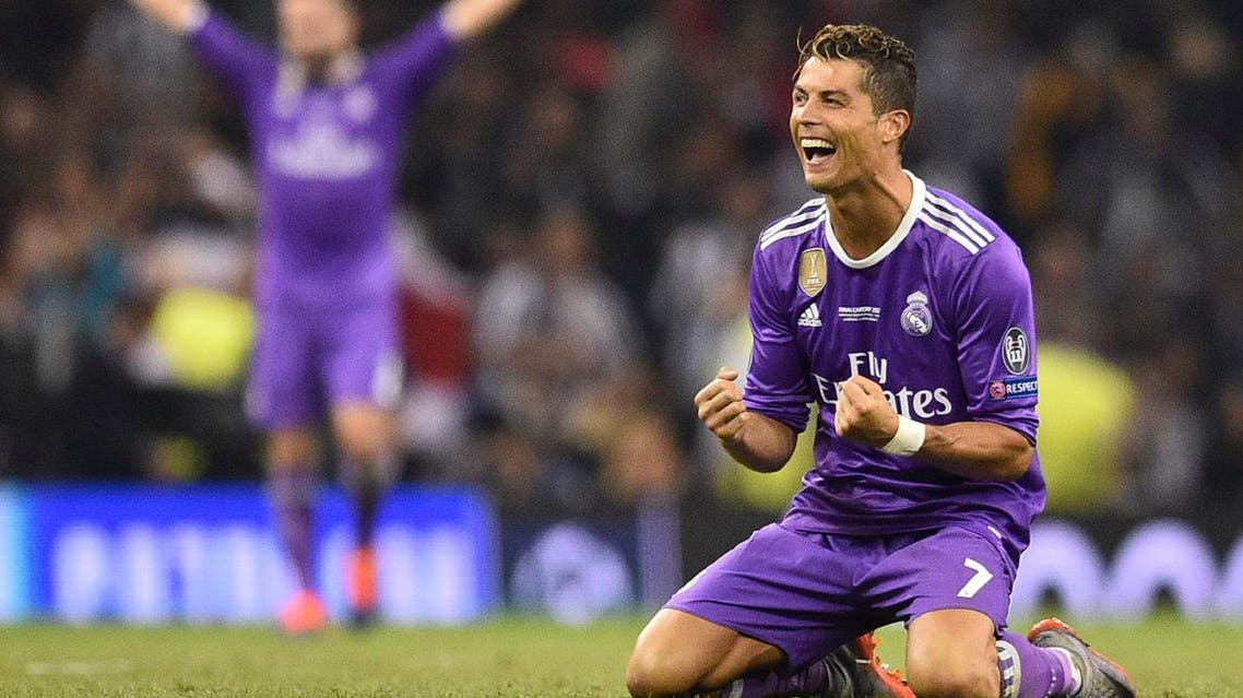 Real Madrid's Portuguese striker Cristiano Ronaldo falls to his knees as he celebrates their victory on the final whistle of the UEFA Champions League final football match between Juventus and Real Madrid at The Principality Stadium in Cardiff, south Wales, on June 3, 2017. Real Madrid beat Juventus 4-1 to win Champions League. AFP
