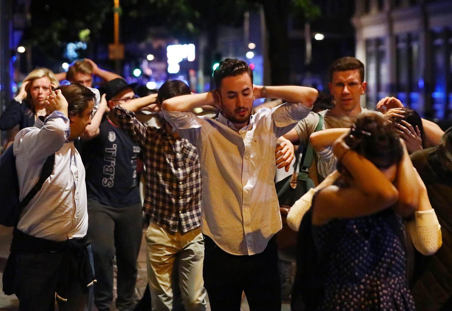 People leave the area with their hands up after an incident near London Bridge in London, Britain June 4, 2017. reuters
