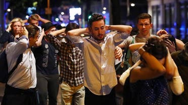 People leave the area with their hands up after an incident near London Bridge in London, Britain June 4, 2017. reuters
