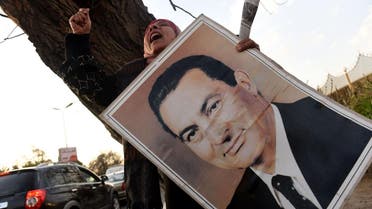 Supporters of Egypt's former president Hosni Mubarak, chant slogans in his support as they gather outside Maadi military hospital in Cairo on March 2, 2017 to welcome him upon his return from a court hearing. (AFP)