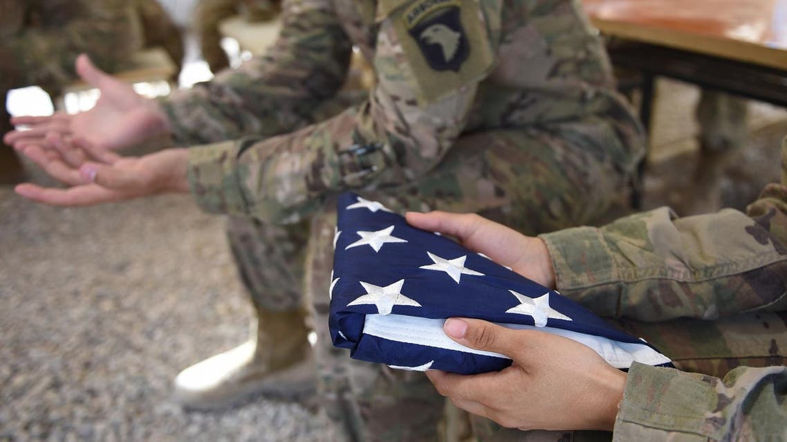 A US soldier holds the national flag ahead of a handover ceremony at Leatherneck Camp in Lashkar Gah in the Afghan province of Helmand on April 29, 2017. (AFP)