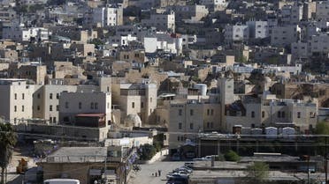 A picture taken on April 6, 2017 shows a general view of the Israeli settlement of Abraham Avino (back) in the centre of the Old City of the Palestinian city of Hebron (bottom) in the occupied West Bank. AFP