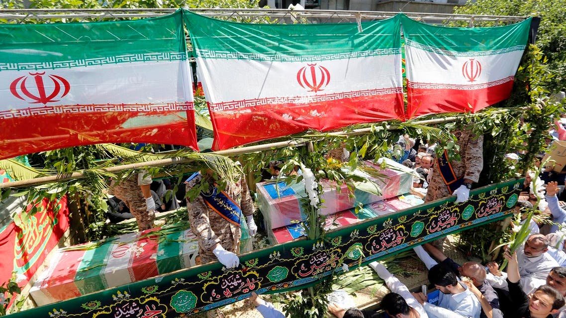 Iranians march during the funeral of the victims of the attacks on Tehran’s parliament complex and the shrine of Ayatollah Khomeini, in Tehran on June 9, 2017. (AFP)