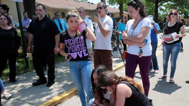 Chaldean-American Lavrena Kenawa (C, standing) cries as she thinks about her uncle who was seized on Sunday by Immigration and Customs Enforcement agents during a rally outside the Mother of God Catholic Chaldean church in Southfield, Michigan, U.S., June 12, 2017. 