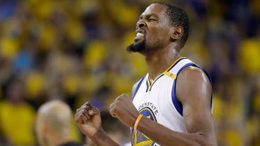 Golden State Warriors forward Kevin Durant reacts after scoring against the Cleveland Cavaliers during the second half of Game 5 of basketball's NBA Finals in Oakland, Calif., Monday, June 12, 2017. (AP Photo/Marcio Jose Sanchez)