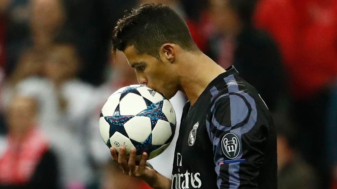 (FILES) This file photo taken on April 12, 2017 shows Real Madrid's Portuguese forward Cristiano Ronaldo kissing the ball before taking a free kick during the UEFA Champions League 1st leg quarter-final football match FC Bayern Munich v Real Madrid in Munich, southen Germany. State prosecutors have filed a complaint on June 13, 2017 against the Portuguese star, who they accuse of taking advantage of a corporate structure to defraud the Spanish Treasury of 14.7 million euros. (AFP)