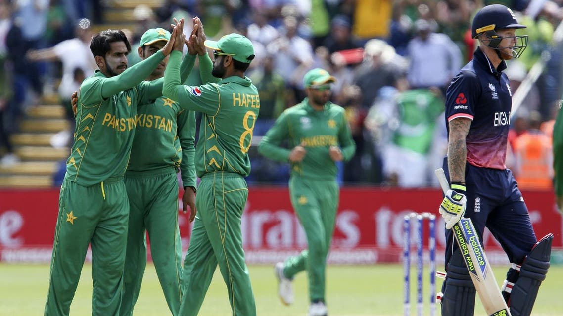 Pakistan's Mohammad Hafeez (C) celebrates with Pakistan's Hasan Ali (L)the wicket of England's Ben Stokes (R) for 34 during the ICC Champions Trophy semi-final cricket match between England and Pakistan in Cardiff on June 14, 2017. (AFP)