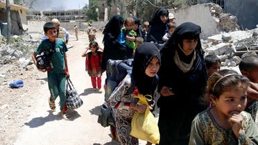 Displaced civilians walk towards the Iraqi Army positions after fleeing their homes due to clashes in the Shifa neighbourhood in western Mosul, Iraq June 15 2017. (Reuters)