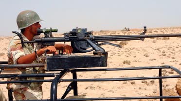 A Djiboutian soldier stands behind a heavy machine gun in an undisclosed location along the border with Eritrea, June 15, 2008. (AReuterS)