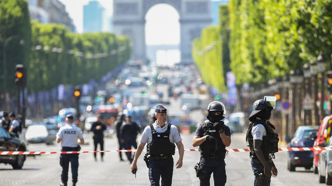 Police officers and anti-riot police officers patrol the Champs-Elysees avenue on June 19, 2017. (AFP)
