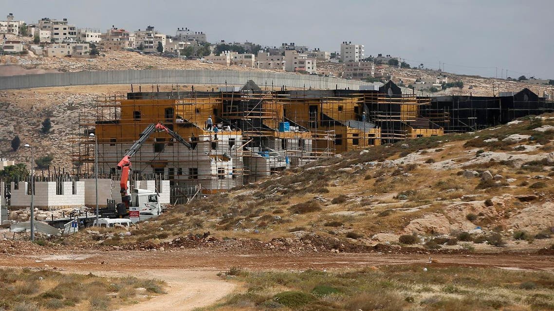 A picture taken on May 21, 2017 shows Israel's controversial barrier separating the Jewish settlement of Neve Yaakov (foreground) in the northern area of east Jerusalem and the Palestinian neighbourhood of al-Ram (background) in the West Bank. (AFP)