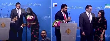 Poet Bilal al-Meer kneels to put a wedding ring on Dina Drawish’s finger in the presence of Lebanese Prime Minister, Saad al-Hariri. (Supplied)
