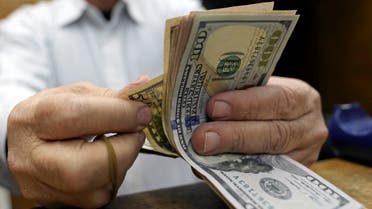 A stock image of a man counting US dollar bills. (File photo: Reuters)