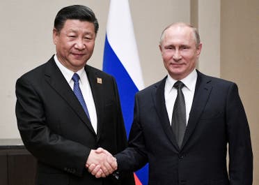 Russian President Vladimir Putin and Chinese President Xi Jinping shake hands at their meeting in Astana, Kazakstan, on June 8, 2017. (AP)