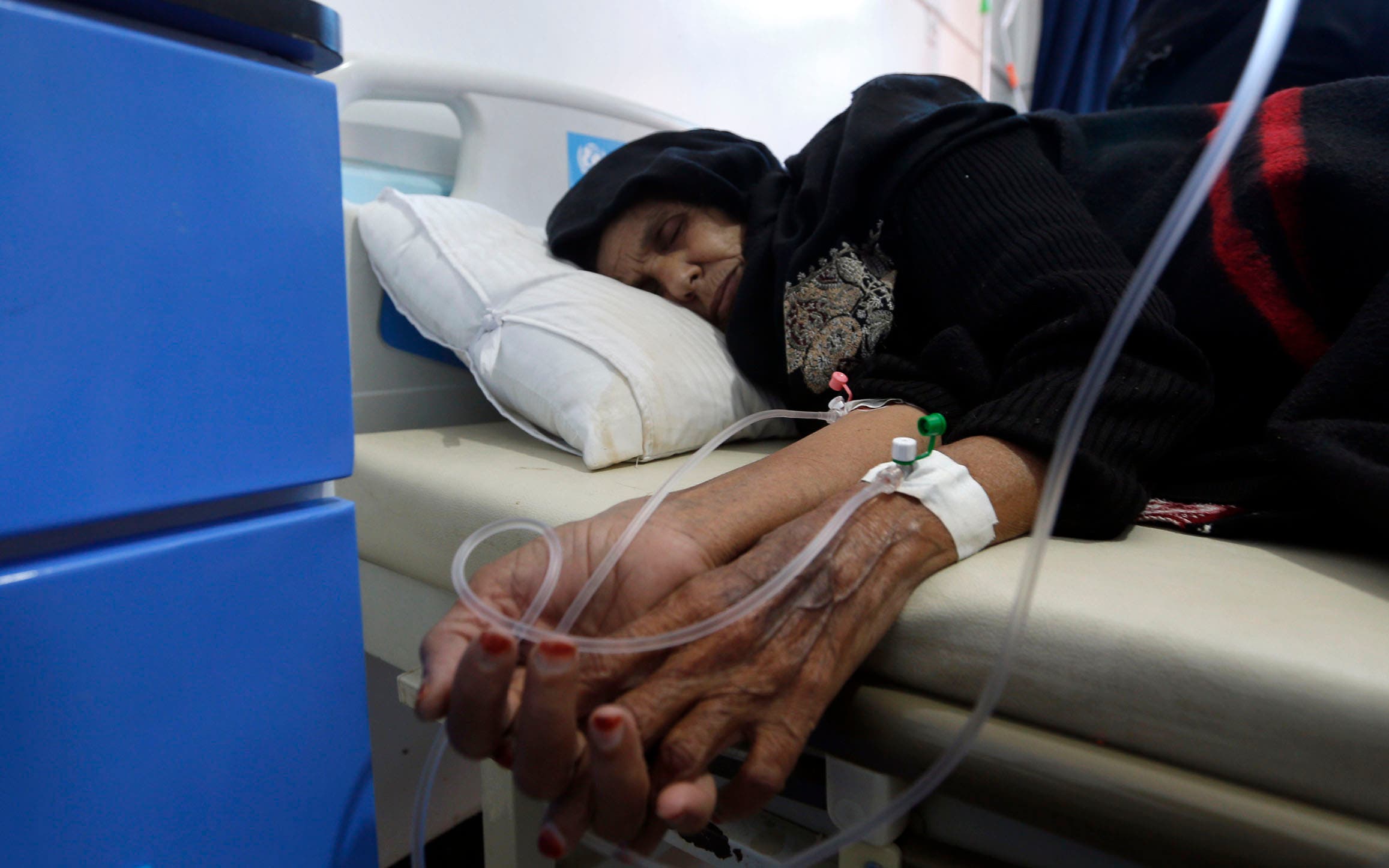 A Yemeni woman suspected of being infected with cholera receives treatment at a hospital in Sanaa on May 25, 2017. (AFP)