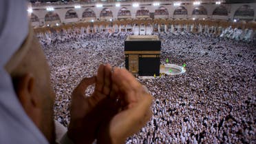 A Muslim worshipper prays during Laylat al-Qadr, Night of Decree, on the 27th day of the holy fasting month of Ramadan as pilgrims circumambulate around the Kaaba, the cubic building at the Grand Mosque, during the minor pilgrimage, known as Umrah, in the Muslim holy city of Mecca, Saudi Arabia, early Thursday, June 22, 2017. (AP)