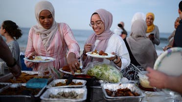 Muslim American friends take part in the last Iftar of Ramadan, ahead of Eid al-Fitr celebrations, on a beach in Long Branch, New Jersey, U.S., June 24, 2017. REUTERS/Amr Alfiky