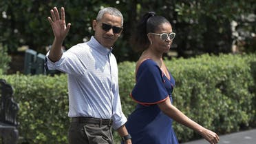 US President Barack Obama and First Lady Michelle Obama make their way to board Marine One on the South Lawn of the White House in Washington, DC on August 6, 2016. Obama and his family were headed to Martha's Vineyard for their summer vacation. (AFP)