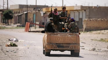 Syrian Democratic Forces (SDF) fighters ride on a pick-up truck along a street in Raqqa's western neighbourhood of Jazra, Syria June 11, 2017. REUTERS/Rodi Said