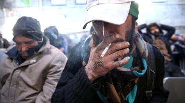 In this Tuesday, Feb. 3, 2015 photo, a drug addict smokes cigarette at drop-in center and shelter south of Tehran, Iran. Anti-narcotics and medical officials say more than 2.2 million of Iran's 80 million citizens already are addicted to illegal drugs, including 1.3 million on registered treatment programs. (AP)